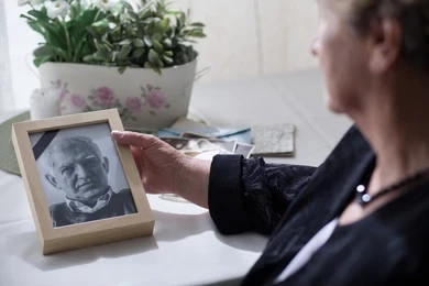 Widow looking at picture of her dead husband